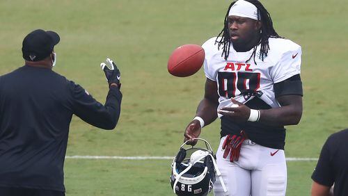 Atlanta Falcons defensive end Takk McKinley takes the field and a football during an NFL training camp football practice Saturday, Aug. 22, 2020, in Flowery Branch, Ga. (Curtis Compton/ccompton@ajc.com)