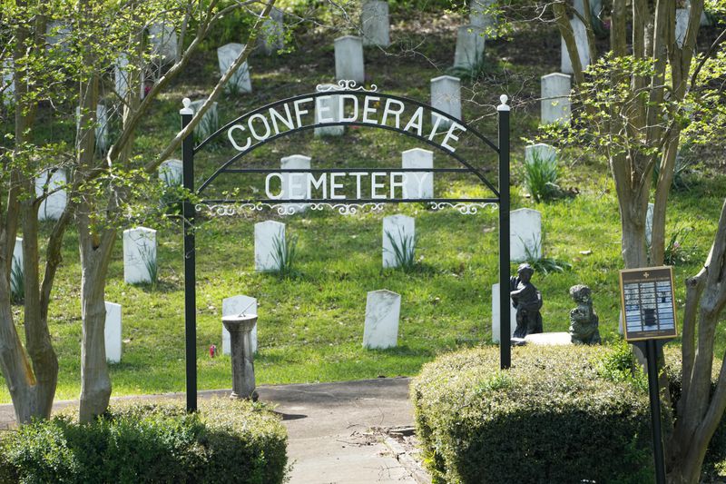 The sun sets on the grave markers in the Confederate Cemetery in Grenada, Miss., April 12, 2023. (AP Photo/Rogelio V. Solis)