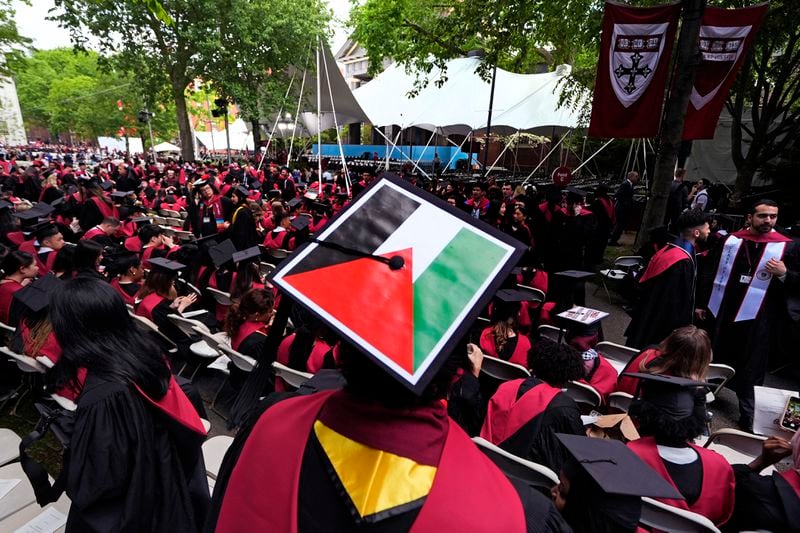 A student displays the Palestinian flag on his mortar board as graduates take their seats in Harvard Yard during commencement at Harvard University, Thursday, May 23, 2024, in Cambridge, Mass. (AP Photo/Charles Krupa)
