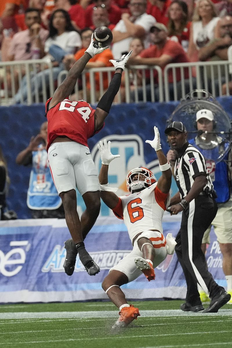 Georgia defensive back Malaki Starks (24) intercepts a pass intended for Clemson wide receiver Tyler Brown (6) during the second half of an NCAA college football game Aug. 31, 2024, in Atlanta. (AP Photo/John Bazemore)