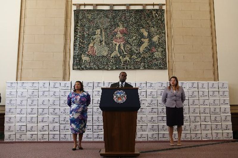 Mayor Kasim Reed stands in front of dozens of boxes of documents related to the Atlanta City hall bribery investigation. The documents were released in February. (HENRY TAYLOR / HENRY.TAYLOR@AJC.COM)