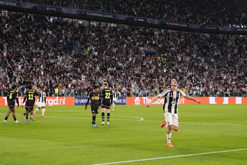 Juventus' Kenan Yildiz celebrates after scoring the opening goal during the Champions League opening phase soccer match between Juventus and PSV Eindhoven at the Juventus stadium in Turin, Italy, Tuesday, Sept. 17, 2024. (Fabio Ferrari/LaPresse via AP)