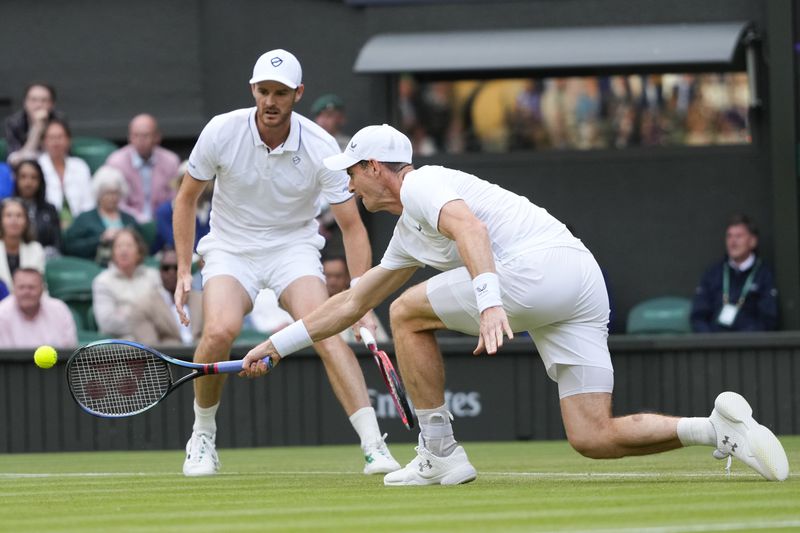 Andy, right, and Jamie Murray in action during their first round doubles match against Australia's John Peers and Ricky Hijikata at the Wimbledon tennis championships in London, Thursday, July 4, 2024. (AP Photo/Kirsty Wigglesworth)