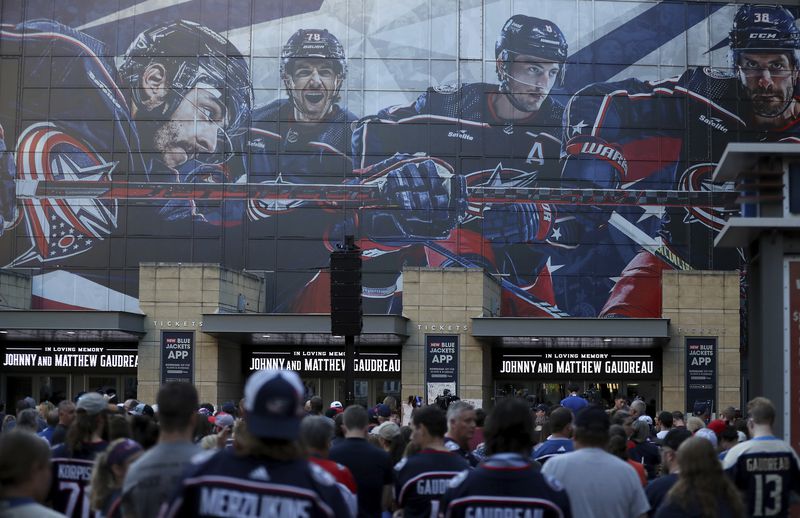 Fans gather for a candlelight vigil to honor Columbus Blue Jackets hockey player Johnny Gaudreau, Thursday, Sept. 4, 2024, outside of Nationwide Arena in Columbus, Ohio. Gaudreau and his brother Matthew were killed by a motor vehicle last week while riding bicycles. (AP Photo/Joe Maiorana)