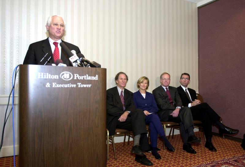 FILE - Former Oregon Gov. Neil Goldschmidt, left, announces that Enron and Portland General Electric have signed an agreement under which Oregon Electric Utility Company will acquire PGE from Enron on Nov. 18, 2003, in Portland, Ore. Goldschmidt, a former Oregon governor whose confession that he had sex with a 14-year-old girl in the 1970s blackened what had been a nearly sterling reputation, has died. He was 83. (AP Photo/Don Ryan, File)