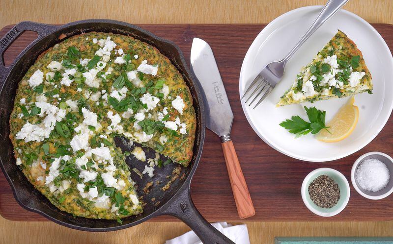 Kuku sabzi, a traditional, heavily herb-filled Persian omelet, is the inspiration for this airy, spring-forward frittata. Overflowing with finely chopped green onions, tarragon, basil and parsley and studded with large crumbles of briny feta, it’s a flavorful and filling meal for brunch or dinner. (Chadwick Boyd for The Atlanta Journal-Constitution)