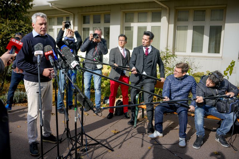 Austrian Chancellor Karl Nehammer speaks to media outside a polling station in Vienna, Austria, Sunday, Sept. 29, 2024, after casting his vote in the country's national election. (AP Photo/Andreea Alexandru)