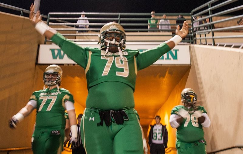 Buford's Shug Frazier lifts his hands as he enters the field to warmups. (Branden Camp/Special to AJC)