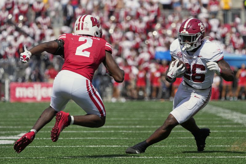 Alabama's Jam Miller (26) gets past Wisconsin's Ricardo Hallman (2) during the second half of an NCAA college football game Saturday, Sept. 14, 2024, in Madison, Wis. (AP Photo/Morry Gash)