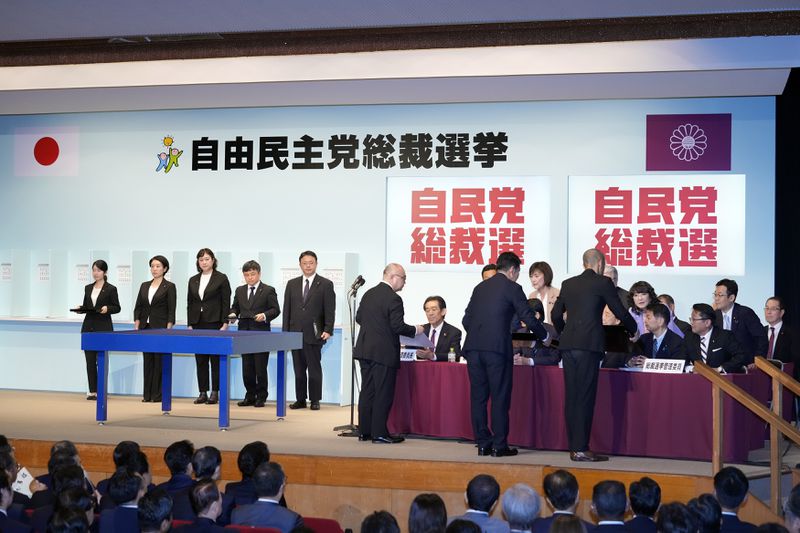 Officials show the result of the first voting to Election Commission during the Liberal Democratic Party's (LDP) leadership election at the party headquarters Friday, Sept. 27, 2024, in Tokyo. (AP Photo/Hiro Komae, Pool)