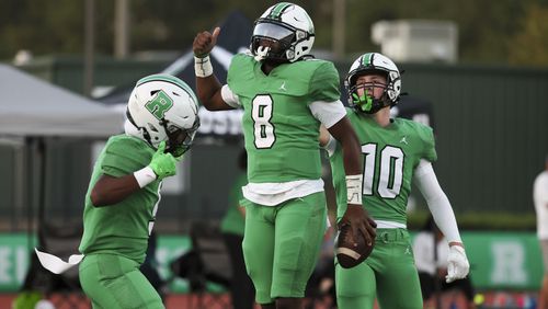 Roswell quarterback Trey Smith (8) celebrates with teammates after his 55-yard touchdown run during the first half against Seckinger at Roswell High School, Friday, Sept. 20, 2024, in Roswell, Ga. (Jason Getz / AJC)

