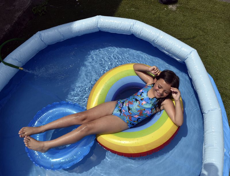 Amyia Garcia, 7, cools off in her backyard pool at her home in Springfield, Mass. (Don Treeger / The Republican)