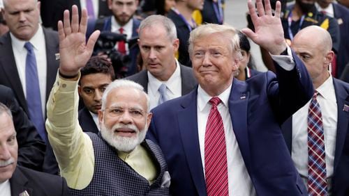 FILE - India Prime Minister Narendra Modi and then President Donald Trump walk the perimeter of the arena floor to greet attendants after Modi's speech during the "Howdi Modi" event, September 22, 2019, at NRG Stadium in Houston. Trump says he’s meeting next week with Indian Prime Minister Narendra Modi. Modi is scheduled to be in the United States this weekend hosted by President Joe Biden in his Wilmington, Delaware hometown along with leaders of Australia and Japan for a summit of the so-called Quad. (AP Photo/Michael Wyke, File)