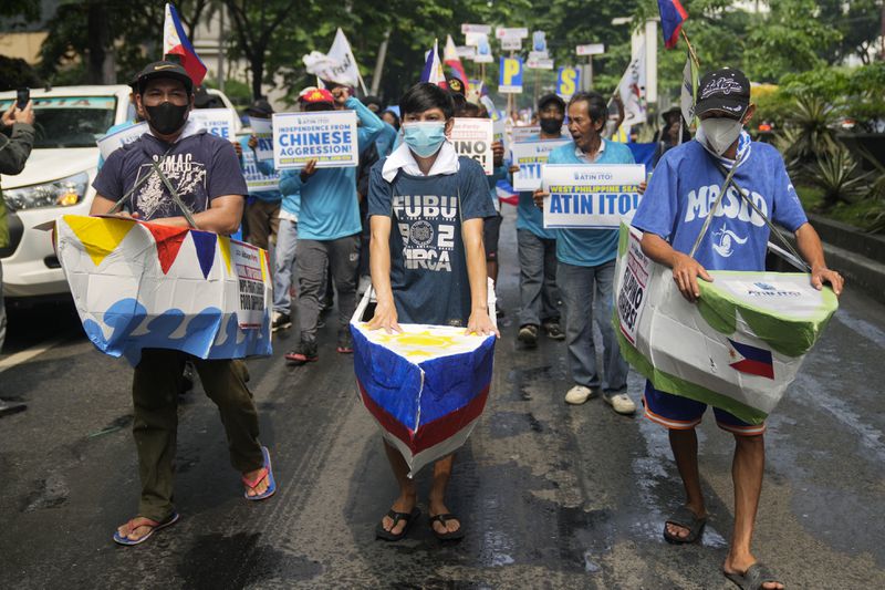 FILE - Filipino fishermen and activists wear boat costumes to protest against alleged Chinese aggression at the disputed South China Sea as they stage a rally in front of the Chinese consulate ahead of Independence Day in Makati, Philippines, June 11, 2024. (AP Photo/Aaron Favila, File)