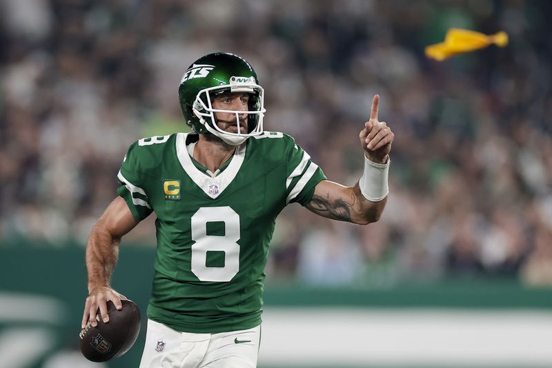 New York Jets quarterback Aaron Rodgers (8) looks to pass against the New England Patriots during the first quarter of an NFL football game, Thursday, Sept. 19, 2024, in East Rutherford, N.J. (AP Photo/Adam Hunger)