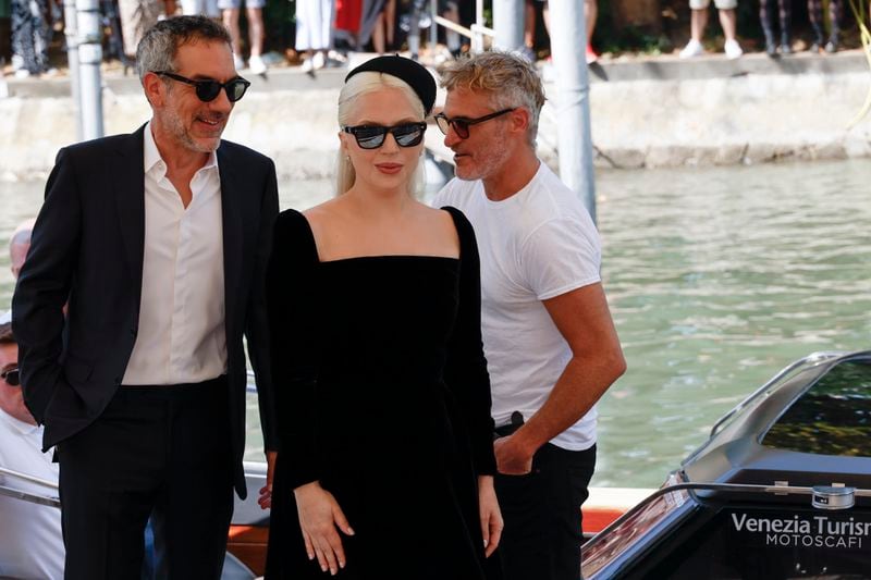 Director Todd Phillips, from left, Lady Gaga and Joaquin Phoenix pose for photographers upon arrival for the press conference of the film 'Joker: Folie A Deux' during the 81st edition of the Venice Film Festival in Venice, Italy, on Wednesday, Sept. 4, 2024. (Photo by Joel C Ryan/Invision/AP)