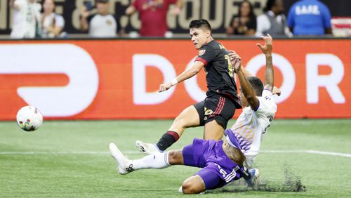 Atlanta United midfielder Luiz Araujo takes a shoot passing Orlando City defender Antonio Carlos during the second half of an MLS game at Mercedes-Benz Stadium on Sunday, July 17, 2022. Miguel Martinez /Miguel.martinezjimenez@ajc.com