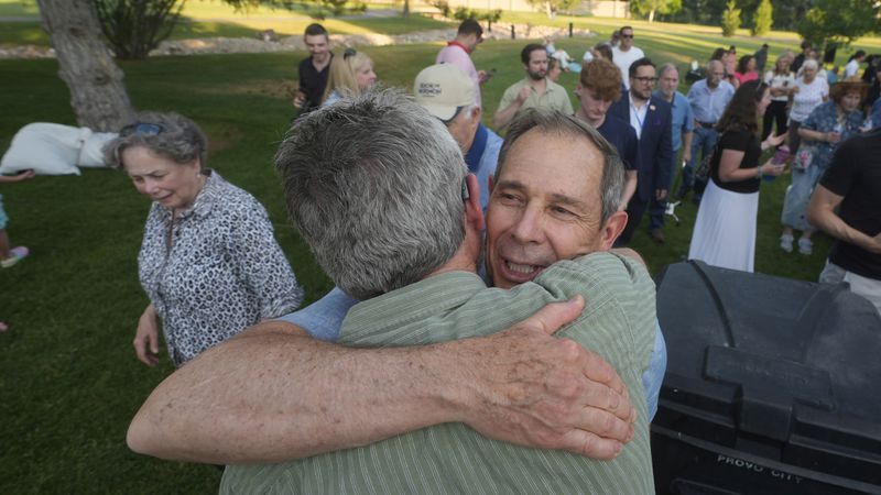 U.S. Rep. John Curtis receives a hug from a supporter following his win during an election night party, Tuesday, June 25, 2024, in Provo, Utah. Curtis has won the Utah GOP primary for Mitt Romney's open U.S. Senate seat, defeating one opponent who was endorsed by former President Donald Trump and others who said they supported Trump's agenda. (AP Photo/Rick Bowmer)