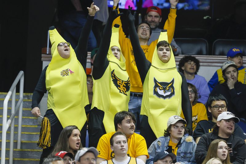 Kennesaw State student wearing banana costumes from left to right; Collin Sheppard, Matthew Bailey, and Cole Ballew cheer during Kennesaw State’s game against Xavier in the first round of the NCAA Tournament at the Greensboro Coliseum, Friday, March 17, 2023, in Greensboro, NC. Jason Getz / Jason.Getz@ajc.com)
