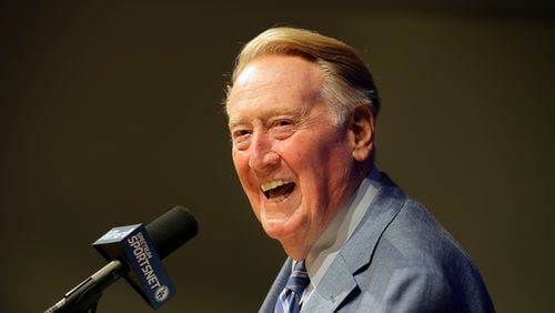 FILE - In this Sept. 24, 2016, file photo, Los Angeles Dodgers and Hall of Fame broadcaster Vin Scully smiles as he answers questions during a news conference at Dodger Stadium in Los Angeles. Scully will receive the Presidential Medal of Freedom on Tuesday at the White House. Scully is one of 21 recipients of the Medal of Freedom announced Wednesday, Nov. 16, 2016, including NBA Hall of Famers Kareem Abdul-Jabbar and Michael Jordan. (AP Photo/Jae C. Hong, File)