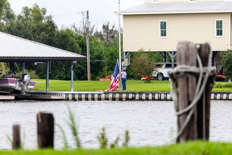 An flag is taken down off a pole as residents of Lafitte prepare for the arrival of Hurricane Francine along the Louisiana coast on Monday, Sept. 9, 2024. (Chris Granger/The Times-Picayune/The New Orleans Advocate via AP)