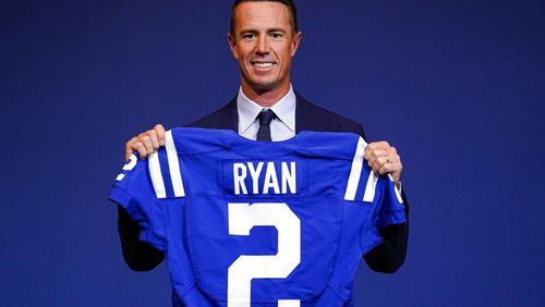 Indianapolis Colts quarterback Matt Ryan holds up his new jersey following a press conference at the NFL team's practice facility in Indianapolis on March 22, 2022.  (AP Photo/Michael Conroy, File)