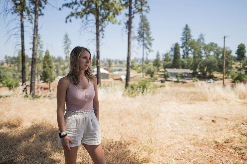 Jen Goodlin, executive director of the Rebuild Paradise Foundation, is shown in Paradise, Calif., Friday, June 14, 2024. With so much cleared terrain in an area once dense with trees, lawn maintenance was a challenge at homes in Paradise. (AP Photo/Nic Coury)