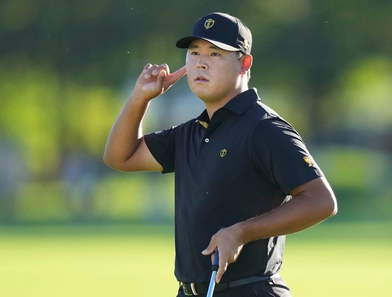 International team member Si Woo Kim, of South Korea, listens to applause after making a putt on the 16th hole during a second-round foursome match at the Presidents Cup golf tournament at Royal Montreal Golf Club, Friday, Sept. 27, 2024 in Montreal. (Nathan Denette/The Canadian Press via AP)