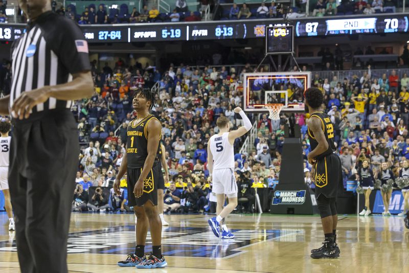 Kennesaw State guard Terrell Burden (1) reacts as time expires as Xavier guard Adam Kunkel (5) celebrates during the first round of the NCAA Tournament at the Greensboro Coliseum, Friday, March 17, 2023, in Greensboro, NC. Kennesaw State lost 72-67 against Xavier. Jason Getz / Jason.Getz@ajc.com)
