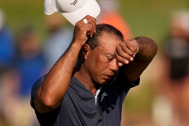 Tiger Woods wipes his face on the 16th hole during weather warnings in the second round of the U.S. Open golf tournament Friday, June 14, 2024, in Pinehurst, N.C. (AP Photo/Mike Stewart)