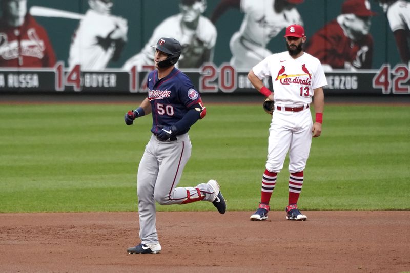 FILE - Minnesota Twins' Brent Rooker (50) rounds the bases past St. Louis Cardinals third baseman Matt Carpenter (13) after hitting a two-run home run during the second inning in the second baseball game of a doubleheader, Tuesday, Sept. 8, 2020, in St. Louis. (AP Photo/Jeff Roberson, File0