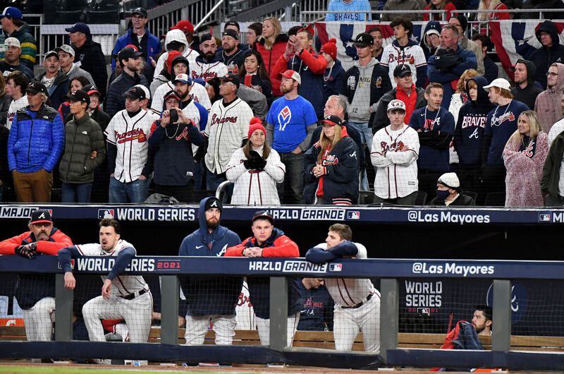 10/31/21 - Atlanta - Atlanta Braves players and fans react during the bottom of the ninth inning trailing the Houston Astros four runs in game 5 of the World Series at Truist Park, Sunday, October 31, 2021, in Atlanta. The Astros won game 5, 9-5. Hyosub Shin / Hyosub.Shin@ajc.com