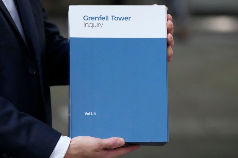 A copy of the Grenfell Tower Inquiry report is shown in London, Wednesday, Sept. 4, 2024, the fire in which 72 people were killed in June 2017, issued Wednesday the on the Grenfell Tower fire, the report says decades of failure by government and industry made the high-rise a "death trap."(AP Photo/Frank Augstein)