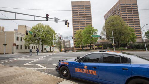 Essential employees must keep reporting to work, including the Georgia State Patrol, Capitol Police as well as janitorial and housekeeping staff who are working in the in the Sloppy Floyd building's cafeteria.  (Jenni Girtman for the Atlanta Journal-Constitution)