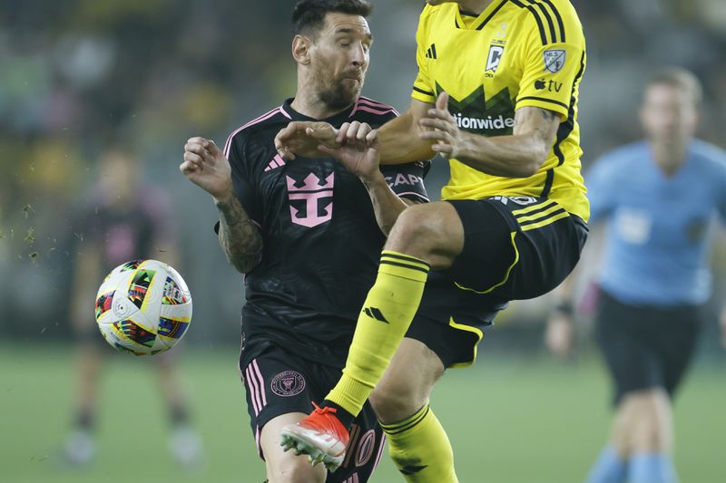 Inter Miami's Lionel Messi, left, collides with Columbus Crew's Malte Amundsen during the second half of an MLS soccer match, Wednesday, Oct. 2, 2024, in Columbus, Ohio. (AP Photo/Jay LaPrete)