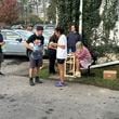 People wait to gather water at Mountain Valley Water in the aftermath of Hurricane Helene in West Asheville, N.C., Monday, Sept. 30, 2024 (AP Photo/Jeffrey Collins)