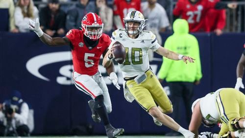 Georgia Tech quarterback Haynes King (10) eludes the rush from Georgia linebacker Raylen Wilson (5) during their game at Bobby Dodd Stadium, Saturday, November 25, 2023, in Atlanta. Georgia won 31-23. (Jason Getz / Jason.Getz@ajc.com)