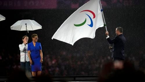 President of the International Paralympic Committee Andrew Parsons passes the Paralympic flag to Mayor of Los Angeles Karen Bass, second left, after receiving it from Mayor of Paris Anne Hidalgo, not pictured, during the closing ceremony of the 2024 Paralympics, Sunday, Sept. 8, 2024, in Paris, France. (AP Photo/Michel Euler)