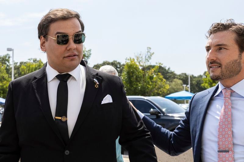 Former U.S. Rep. George Santos, left, arrives at court with his lawyer, Andrew Mancilla, in Central Islip, N.Y., Monday, Aug. 19, 2024. (AP Photo/Stefan Jeremiah)