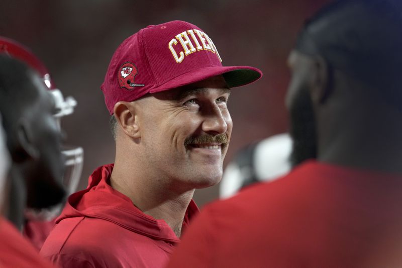 Kansas City Chiefs tight end Travis Kelce smiles on the sidelines during the first half of an NFL preseason football game against the Chicago Bears Thursday, Aug. 22, 2024, in Kansas City, Mo. (AP Photo/Ed Zurga)