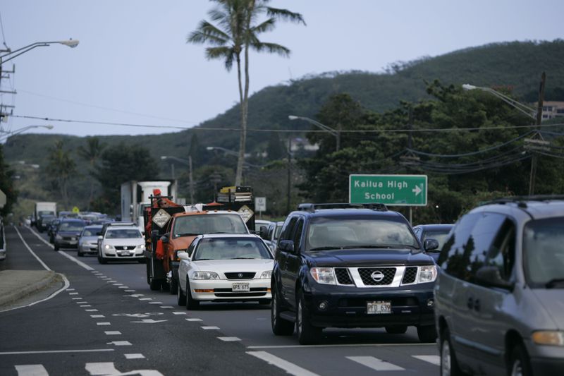FILE - Heavy traffic is seen Monday, Dec. 28, 2009 in Kailua, Hawaii on the island of Oahu. About two years after 13 children and teens in Hawaii sued the state over the threat posed by climate change, both sides reached a settlement that includes an ambitious requirement to decarbonize Hawaii’s transportation system in the next 21 years. (AP Photo/Marco Garcia, File)