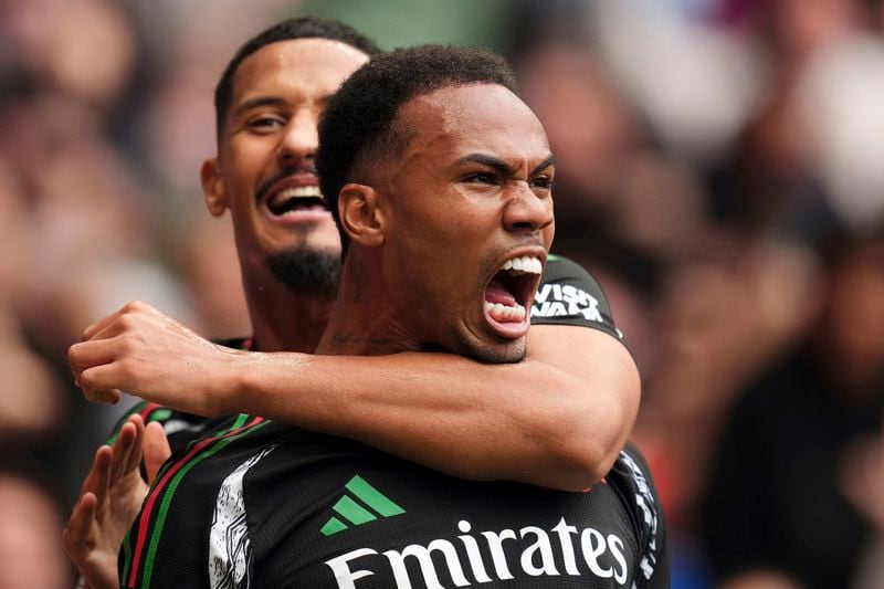 Arsenal's Gabriel, foreground, celebrates with teammate William Saliba after scoring the opening goal during the English Premier League soccer match between Tottenham Hotspur and Arsenal in London, Sunday, Sept. 15, 2024. (John Walton/PA via AP)