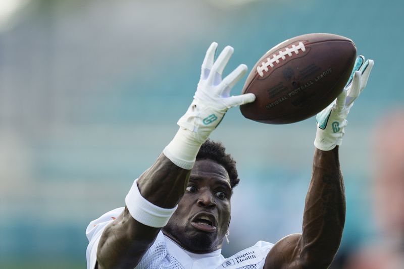 Miami Dolphins wide receiver Tyreek Hill (10) catches a pass during a team practice session, Wednesday, Sept. 11, 2024, in Miami Gardens, Fla. (AP Photo/Rebecca Blackwell)