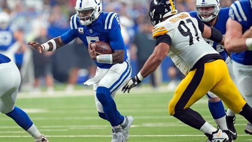 Indianapolis Colts quarterback Anthony Richardson (5) with Pittsburgh Steelers defensive tackle Cameron Heyward (97) in pursuit during the first half of an NFL football game Sunday, Sept. 29, 2024, in Indianapolis. (AP Photo/Michael Conroy)