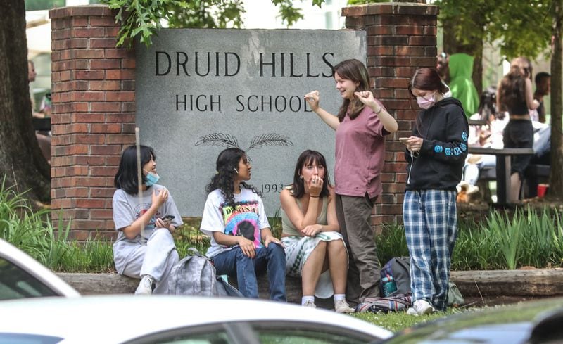 Students could be seen outside of Druid Hills High School after a lockdown was lifted following reports of an armed suspect in the area.