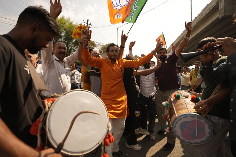 Bharatiya Janata Party (BJP) supporters dance and celebrate a party candidate's victory in Jammu, India, Tuesday, Oct.8, 2024. (AP Photo/Channi Anand)