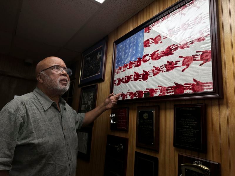 Rep. Bennie Thompson, D-Miss., shows artwork, completed by Elementary School students, from his office on Wednesday, Aug. 14, 2024, in Bolton, Miss. (AP Photo/Stephen Smith)