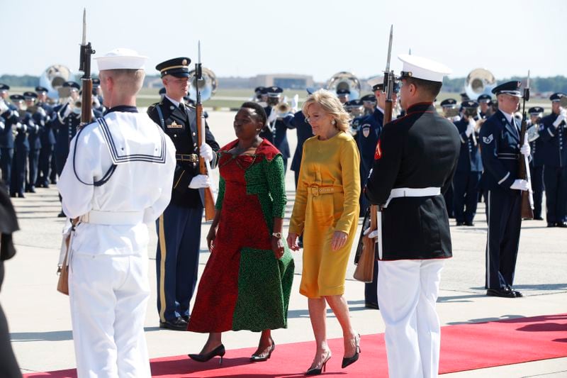 First lady Jill Biden, center in yellow, walks with Kenya's first lady Rachel Ruto, at left in green, as she and Kenya's President William Ruto, not shown, arrive at Andrews Air Force Base, Md., Wednesday, May 22, 2024, for a state visit to the United States. (AP Photo/Luis M. Alvarez)