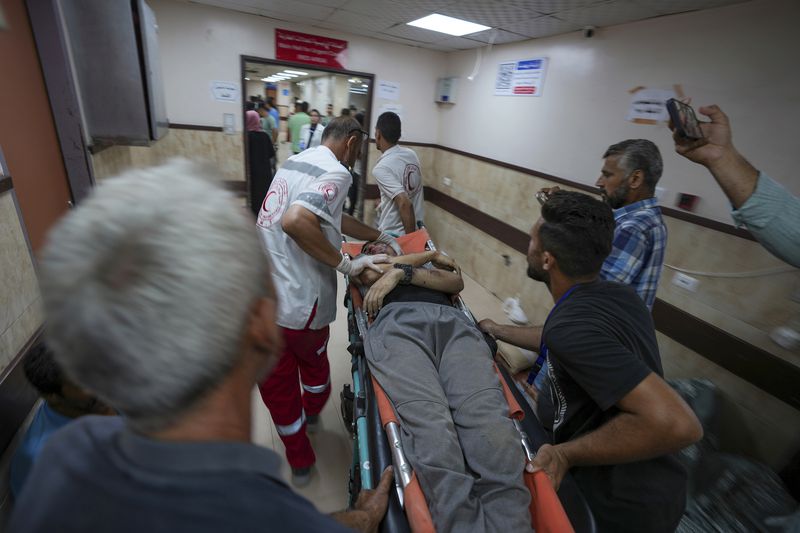 A Palestinian wounded in an Israeli bombardment of Nuseirat refugee camp, is brought to al-Aqsa Martyrs Hospital in Deir al Balah, central Gaza Strip, Saturday, June 29, 2024. (AP Photo/Abdel Kareem Hana)
