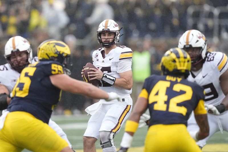 Minnesota quarterback Max Brosmer (16) prepares to throw during the first half of an NCAA college football game against Michigan, Saturday, Sept. 28, 2024, in Ann Arbor, Mich. (AP Photo/Carlos Osorio)